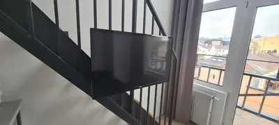 a flat screen tv on the side of a balcony at Stay in Kaunas & LA51 Loft - Free Parking in Kaunas