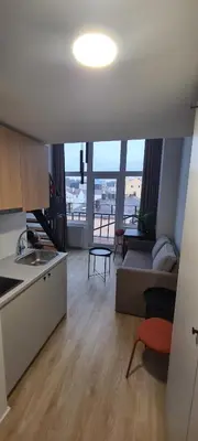 a kitchen and living room with a couch and a table at Stay in Kaunas & LA51 Loft - Free Parking in Kaunas