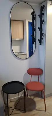 a mirror and a table and a stool in a room at Stay in Kaunas & LA51 Loft - Free Parking in Kaunas