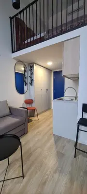 a living room with a couch and a table at Stay in Kaunas & LA51 Loft - Free Parking in Kaunas