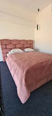 a large bed in a bedroom with a pink blanket at Stay in Kaunas & LA51 Loft - Free Parking in Kaunas