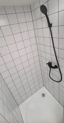 a shower with a shower head in a bathroom at Stay in Kaunas & LA51 Loft - Free Parking in Kaunas