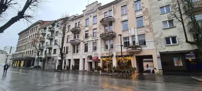 a city street with buildings on a rainy day at Stay in Kaunas & LA51 Loft - Free Parking in Kaunas