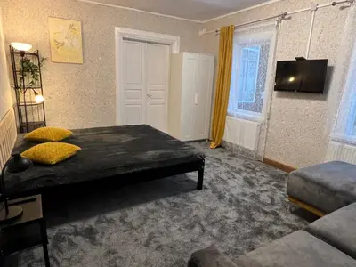 a bedroom with a bed with yellow pillows on it at Villa Arjola in Kaltanėnai