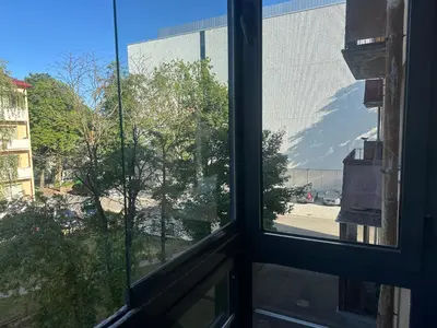 a window with a view of a parking lot at Topoliai Apartament Self check -in in Panevėžys