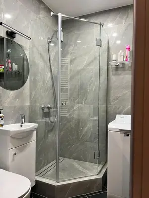 a shower with a glass door in a bathroom at Topoliai Apartament Self check -in in Panevėžys