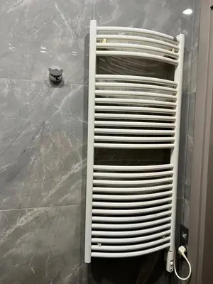 a white metal towel rack in a bathroom at Topoliai Apartament Self check -in in Panevėžys