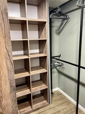a closet with wooden shelves and a glass door at Siauliai ‘Four sisters’ in Šiauliai