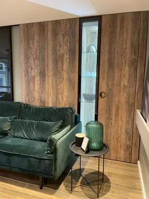 a living room with a green couch and a table at Siauliai ‘Four sisters’ in Šiauliai