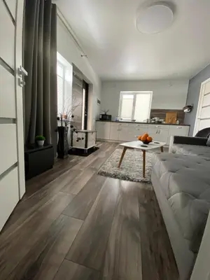 a living room with a couch and a table at Trumpalaikė Nuoma-Apgyvendinimas in Rokiškis