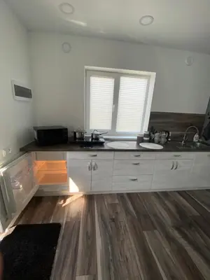 a kitchen with a sink and a counter top at Trumpalaikė Nuoma-Apgyvendinimas in Rokiškis