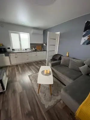 a living room with a couch and a table at Trumpalaikė Nuoma-Apgyvendinimas in Rokiškis