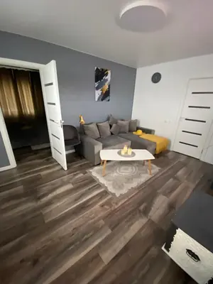 a living room with a couch and a table at Trumpalaikė Nuoma-Apgyvendinimas in Rokiškis
