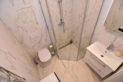 a bathroom with a shower and a toilet and a sink at Naujai įrengtas 2-jų kambarių butas in Šiauliai