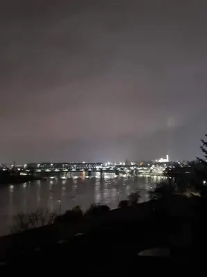 a view of a river at night with a city at River view appartment in Kaunas in Kaunas