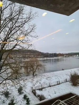 a view of a river with snow on the ground at River view appartment in Kaunas in Kaunas