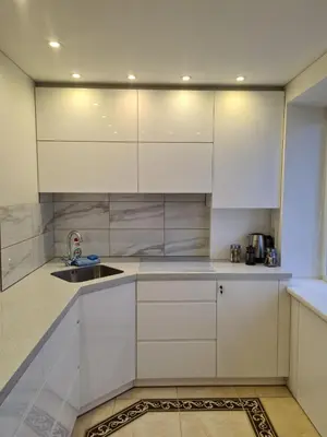 a kitchen with white cabinets and a sink at River view appartment in Kaunas in Kaunas