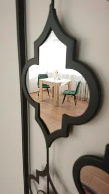 a reflection of a table and chairs in a mirror at Stay in center #Šiauliai in Šiauliai