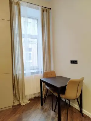 a dining room with a table and chairs and a window at Stylish Central Station Old Town Apart FREE PARKING in Vilnius