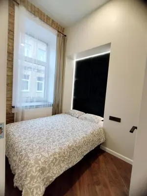 a bedroom with a bed and a window at Stylish Central Station Old Town Apart FREE PARKING in Vilnius