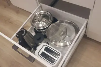 a drawer filled with kitchen utensils and a scale at Studio Mindaugas in Vilnius