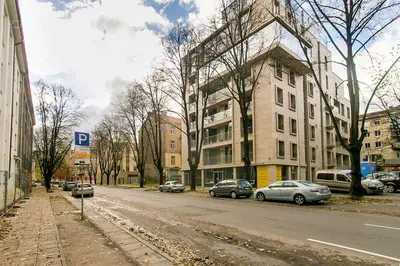 a city street with cars parked on the side of the road at Studio Mindaugas in Vilnius