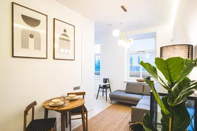 a living room with a table and a couch at Old Town Apartment in Kaunas