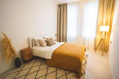 a bedroom with a bed and a large window at Old Town Apartment in Kaunas