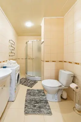 a bathroom with a toilet and a sink and a shower at Lovely city panorama apartment by Polo Apartments in Kaunas