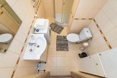 a bathroom with a sink and a toilet at Lovely city panorama apartment by Polo Apartments in Kaunas