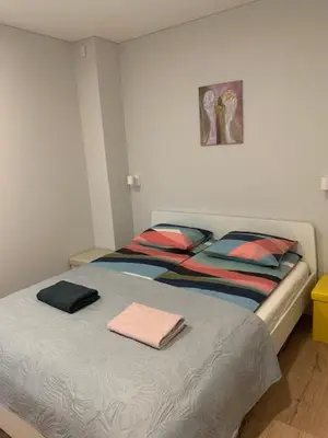 a bed with towels on it in a bedroom at Cozy apartment in Karmelava in Karmėlava