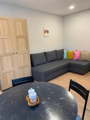 a living room with a table and a couch at Cozy apartment in Karmelava in Karmėlava