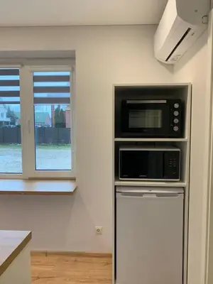 a kitchen with a microwave and a refrigerator at Cozy apartment in Karmelava in Karmėlava