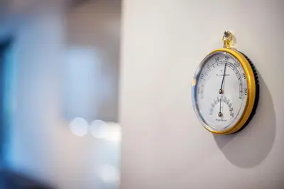 a clock hanging on the side of a wall at Business Apartment In Jaksto Street in Vilnius