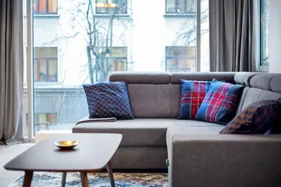 a living room with a couch and a table at Business Apartment In Jaksto Street in Vilnius