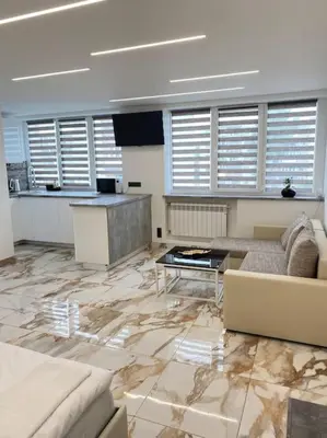 a living room with a couch and a table at Ukmergė Apartments in Ukmergė