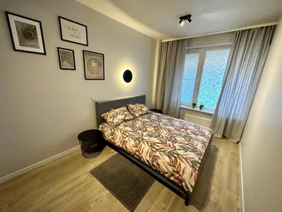 a small bedroom with a bed and a window at Liepu Apartments Druskininkai in Druskininkai