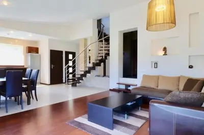 a living room with a couch and a table at 3-bedroom villa surrounded by beautiful nature in Vaišvydava