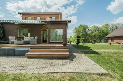 a home with a deck and a house at 3-bedroom villa surrounded by beautiful nature in Vaišvydava