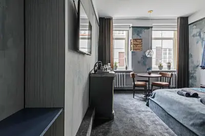 a hotel room with a bed and a table at Luxuriuos flat in the capital's old town in Vilnius