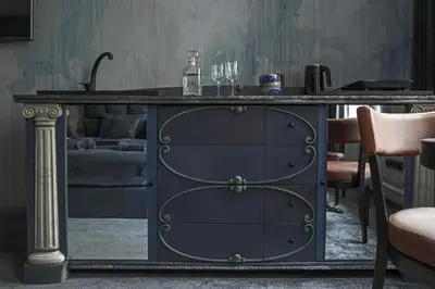 a blue cabinet in a room with a couch at Luxuriuos flat in the capital's old town in Vilnius