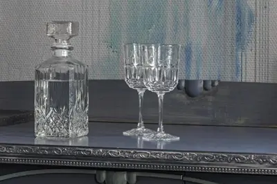 two wine glasses and a bottle on a table at Luxuriuos flat in the capital's old town in Vilnius