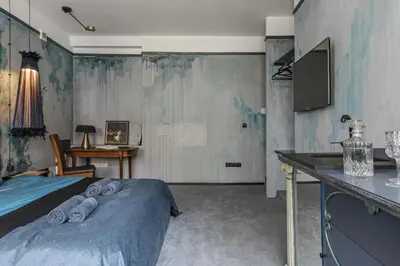 a bedroom with a bed with towels on it at Luxuriuos flat in the capital's old town in Vilnius