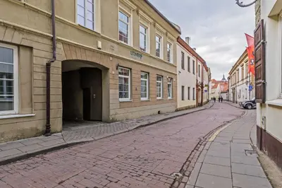 an empty street in a city with buildings at Luxuriuos flat in the capital's old town in Vilnius
