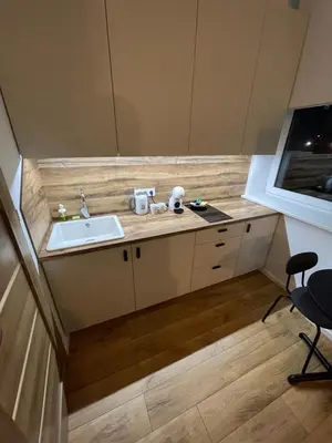 a small kitchen with a sink and a counter at 32 Airport Apartment in Vilnius