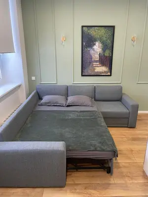 a living room with a couch and a table at 32 Airport Apartment in Vilnius