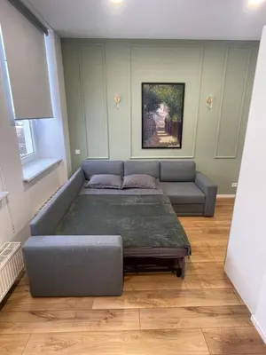 a living room with a couch and a bed at 32 Airport Apartment in Vilnius