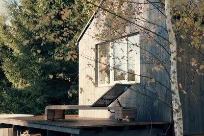 a bird house sitting on a picnic table at Hand made Off Grid forest Cabin Luna in Luksine