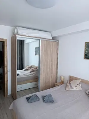 a bedroom with a bed with a large mirror at Bruklinas in Šiauliai