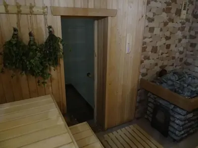 a room with a fireplace and a room with at Sodyba PILIAKIEMIS in Kurkliškės